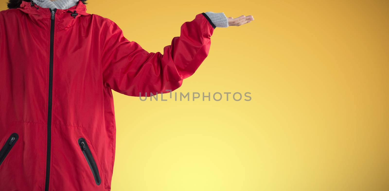 Blissful woman standing with arms outstretched against abstract yellow background