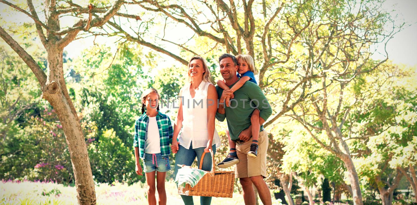 Family arriving in the park for picnic by Wavebreakmedia