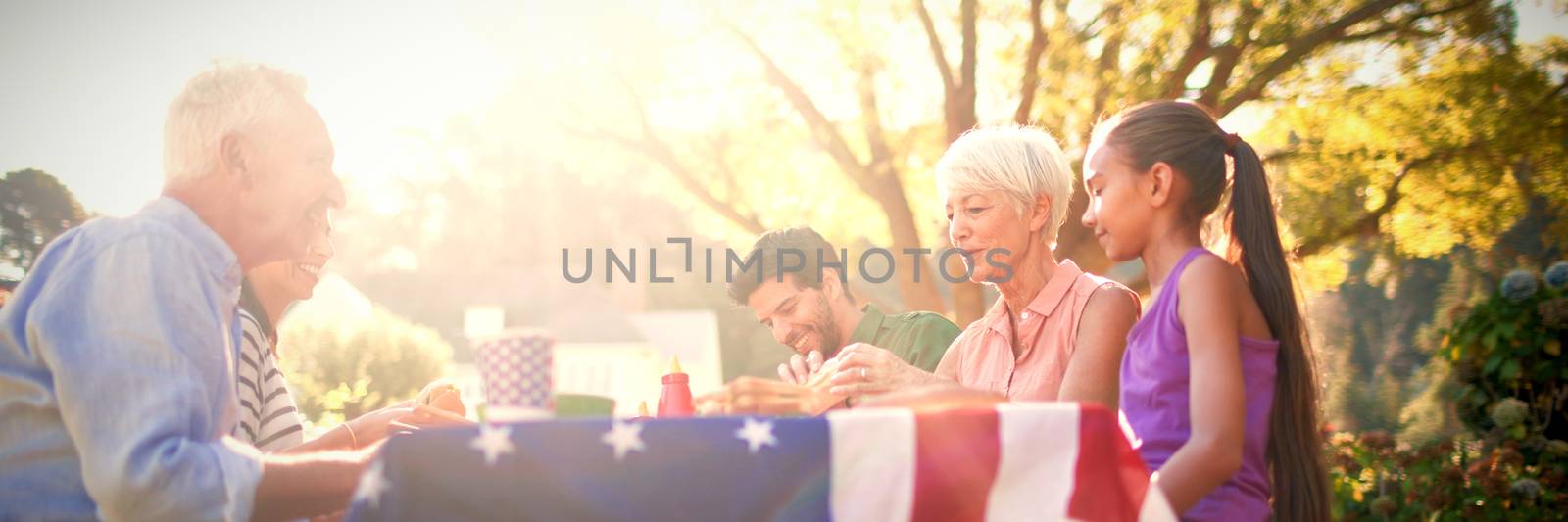 Happy family having a picnic on an american tableclothe