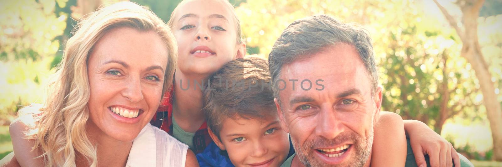 Portrait of happy family in park on a sunny day