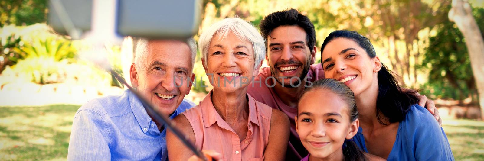 Smiling family taking a selfie in the park