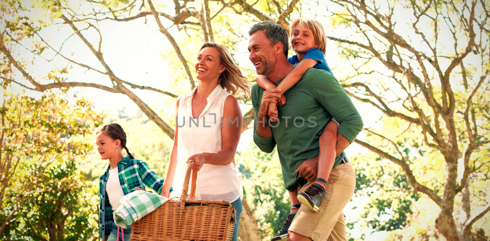 Family arriving in the park for picnic on a sunny day by Wavebreakmedia