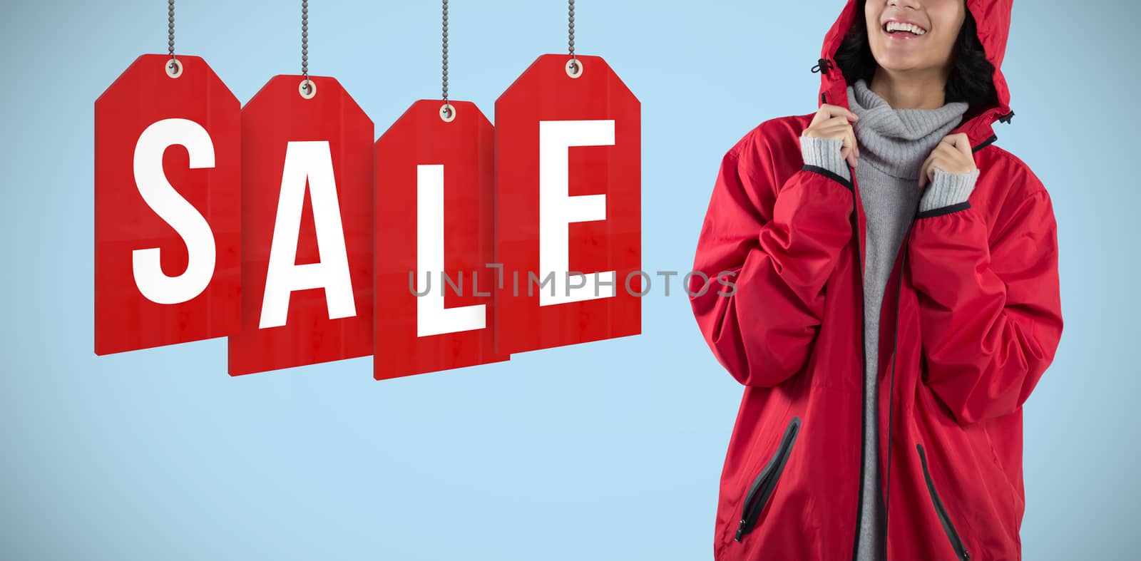 Woman in hooded jacket standing against white background against blue background