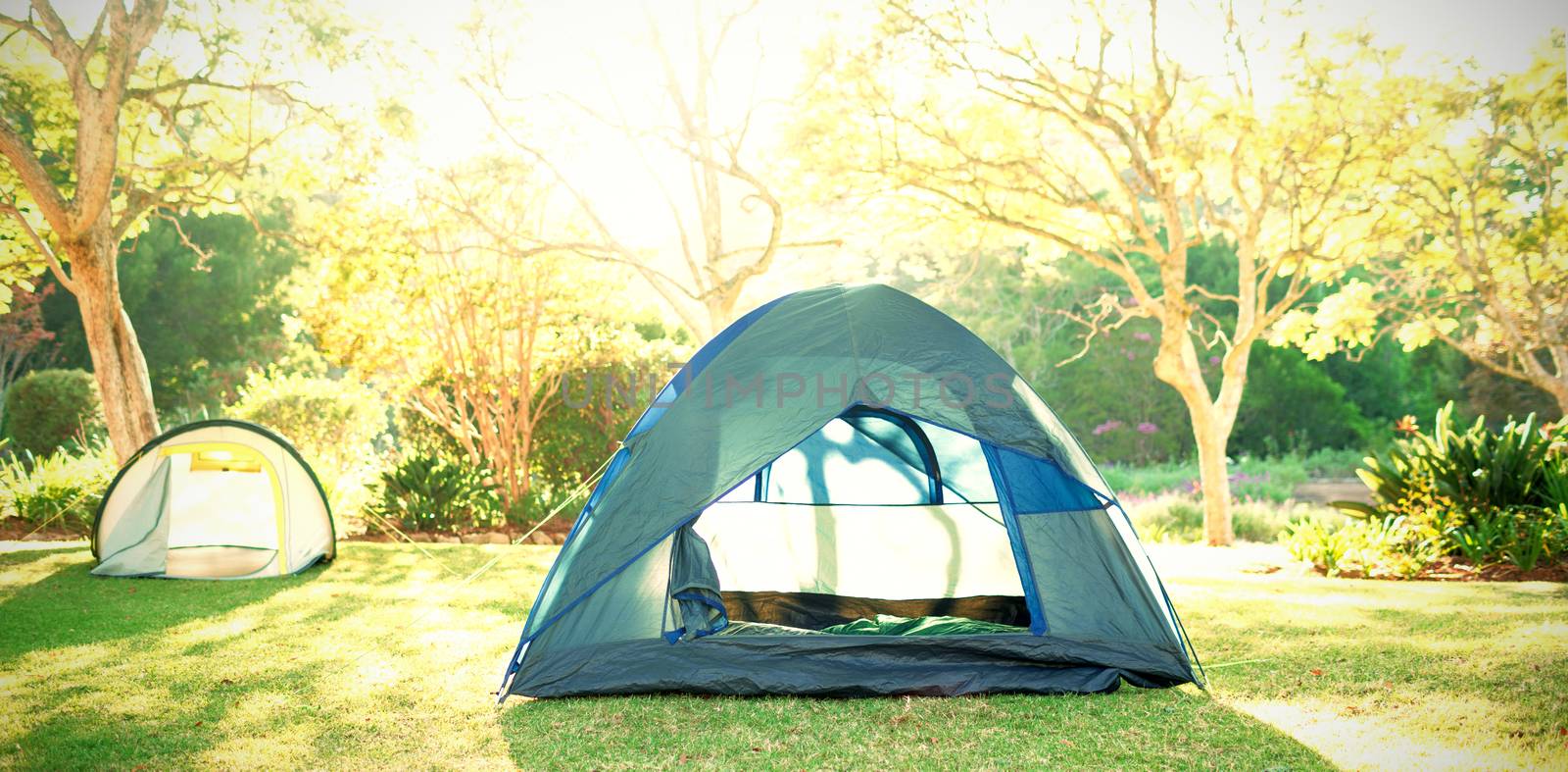 Two tents at campsite on a sunny day