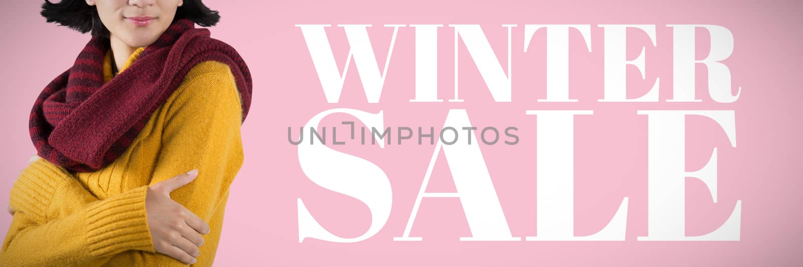 Woman in winter clothing posing against white background against pink background