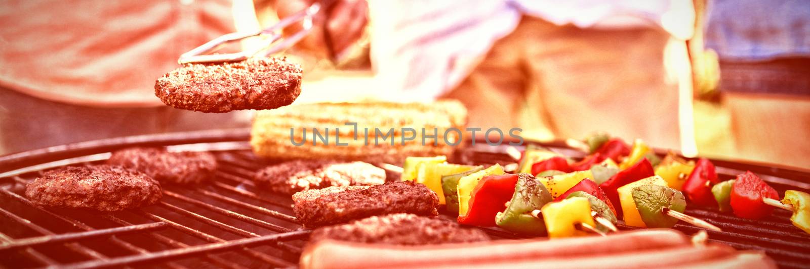 Man holding a minced beef on a barbecue 