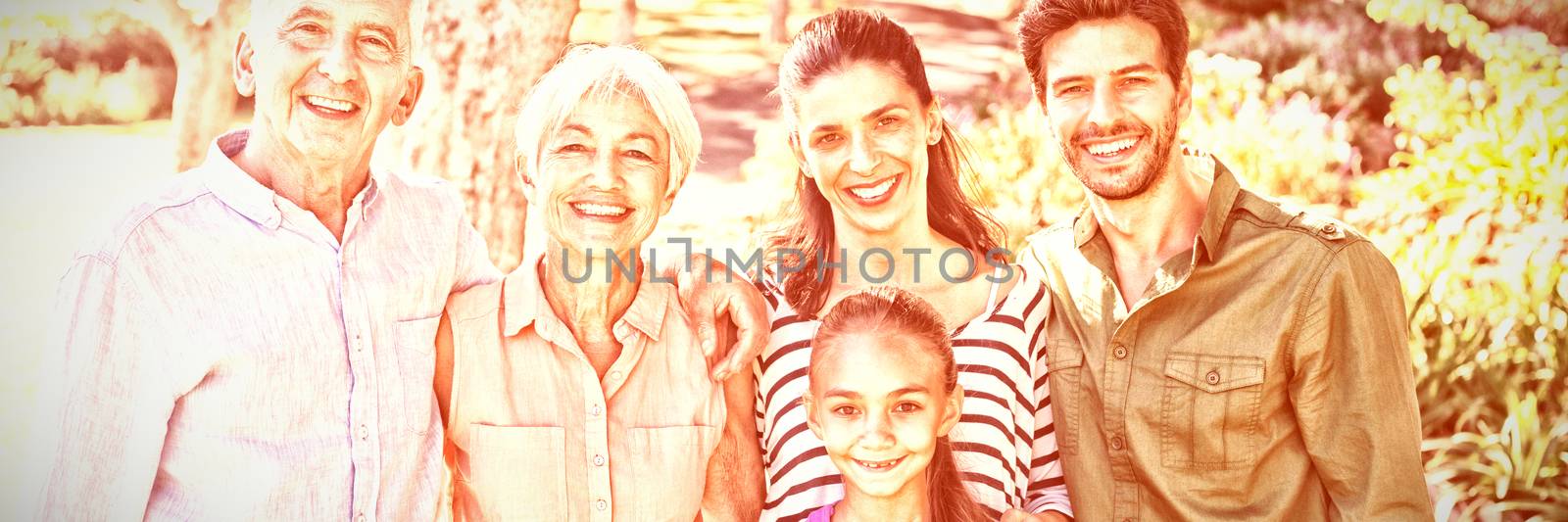 Portrait of happy family standing together in the park