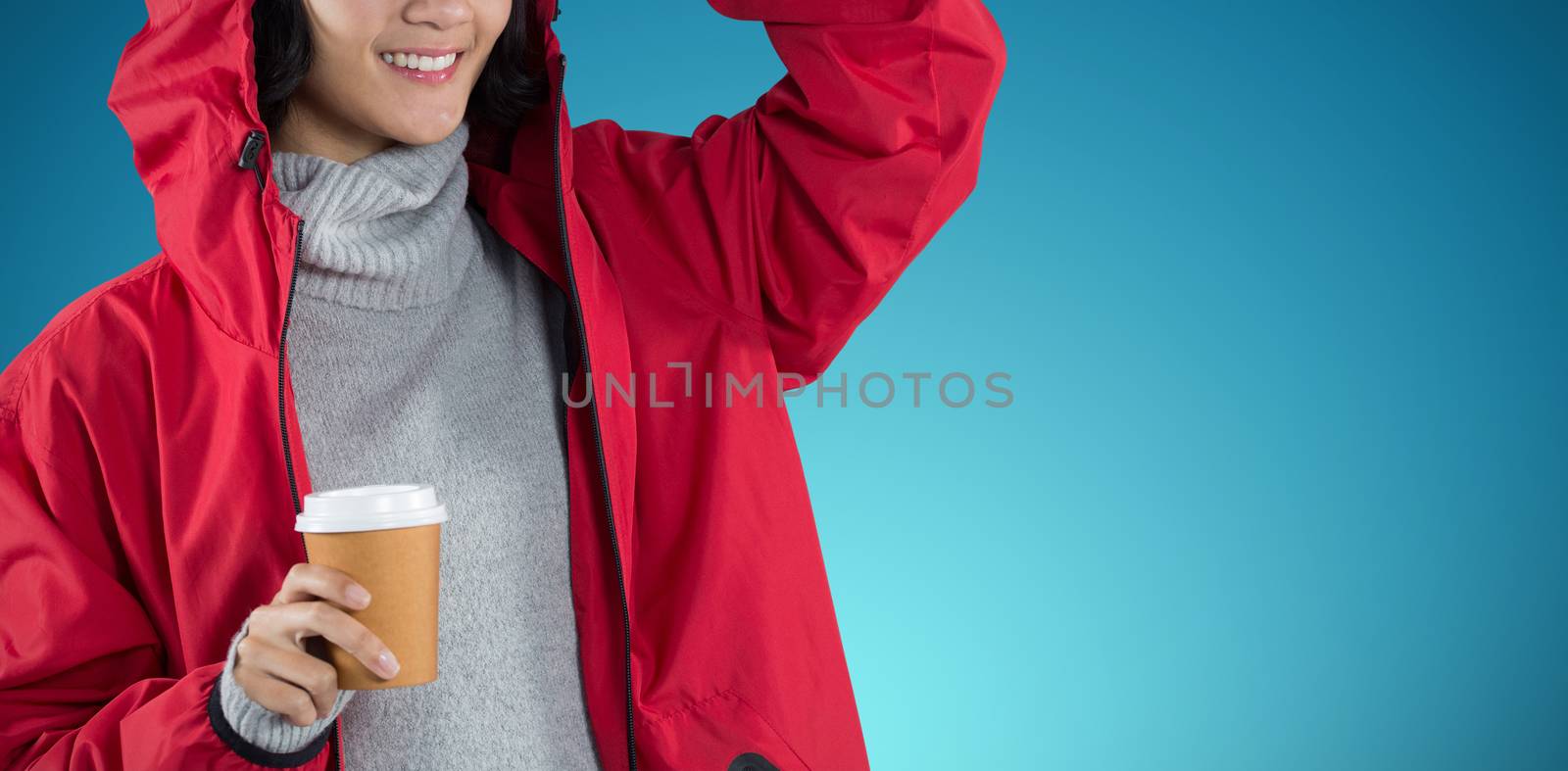 Composite image of woman in red jacket having coffee against white background by Wavebreakmedia