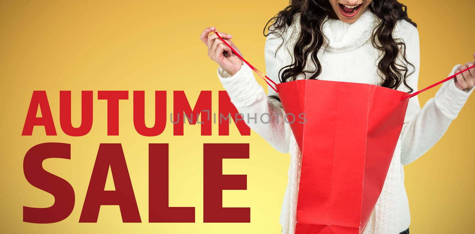 Surprised woman with christmas hat looking in red shopping bag against abstract yellow background
