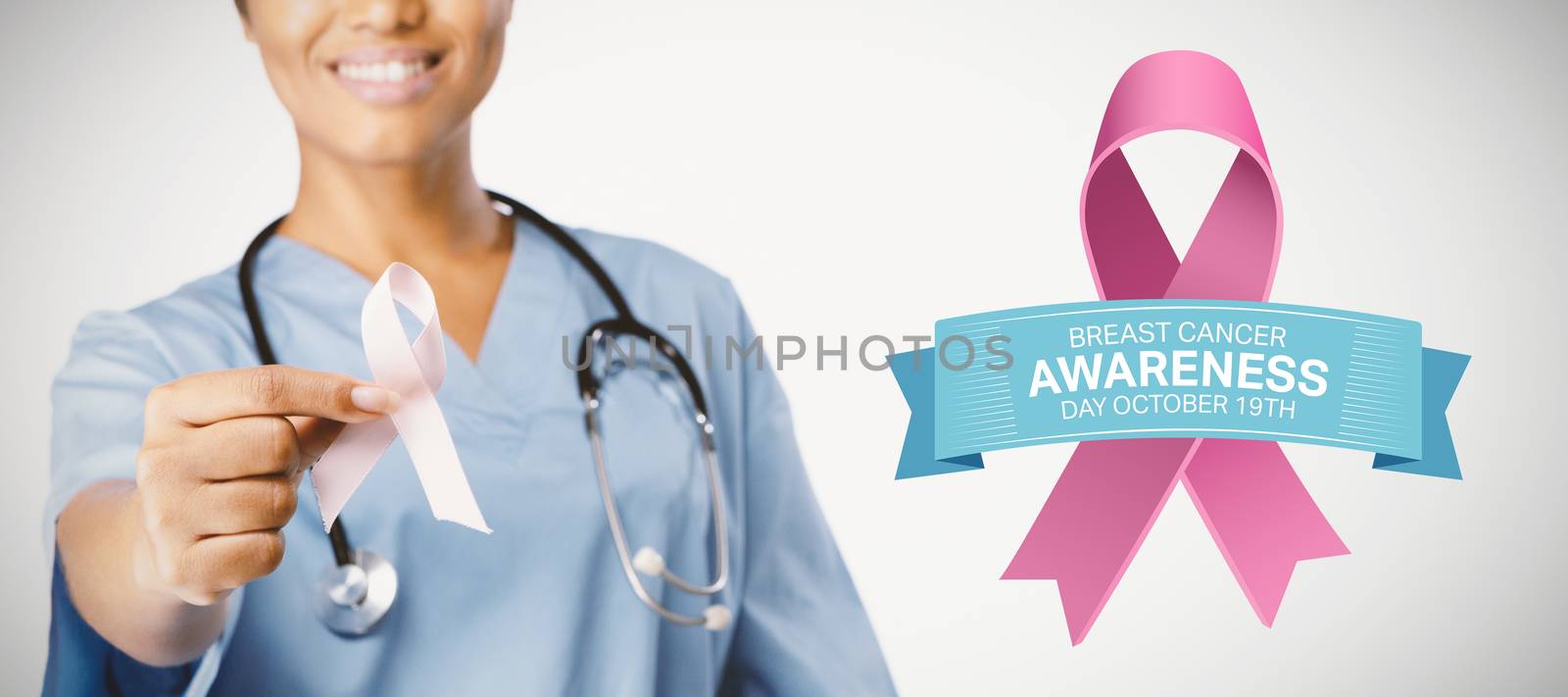 Breast cancer awareness message against smiling nurse holding breast cancer awareness pink ribbon between her fingers