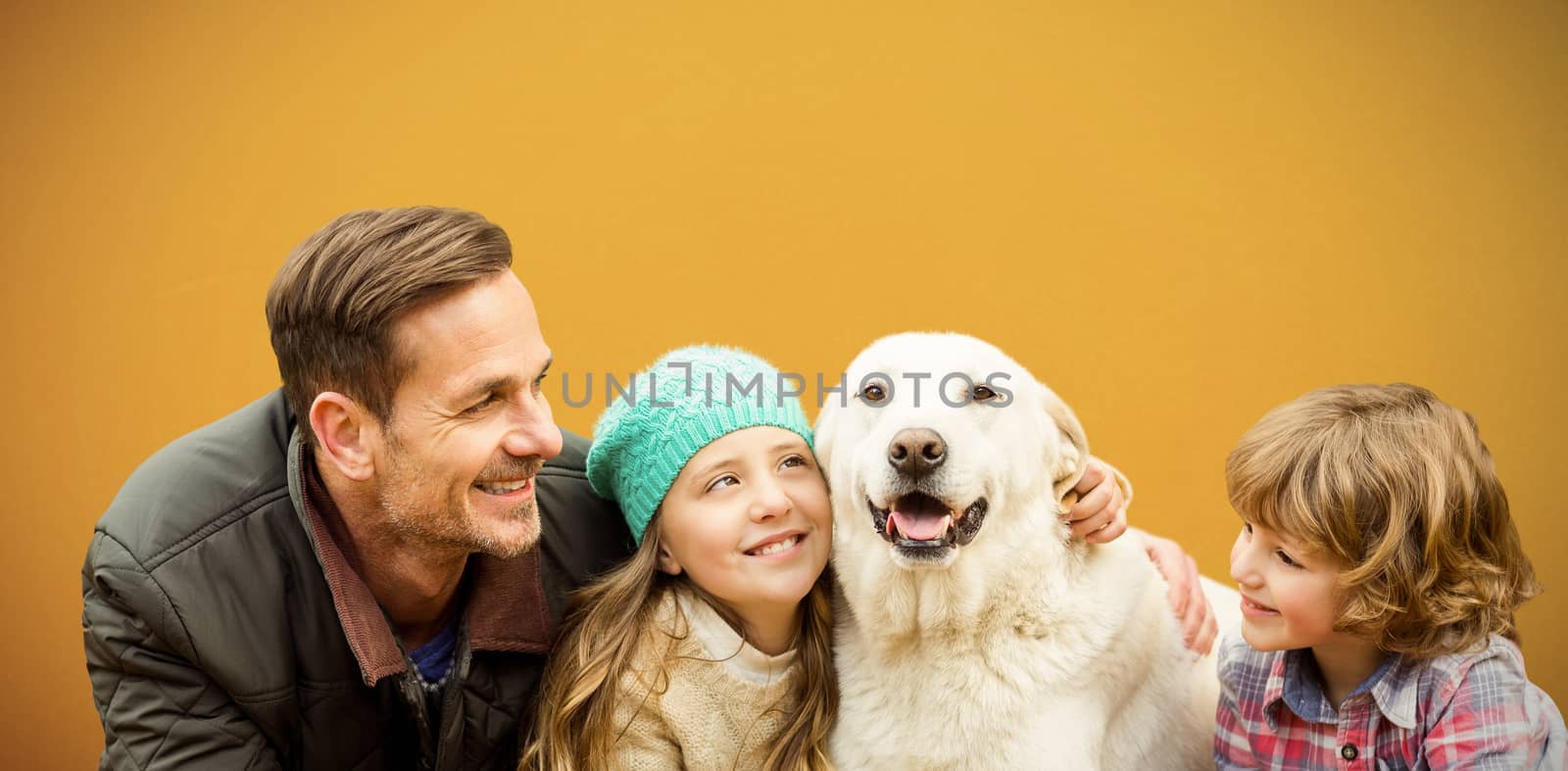  Happy family enjoying with dog in leaves against orange background