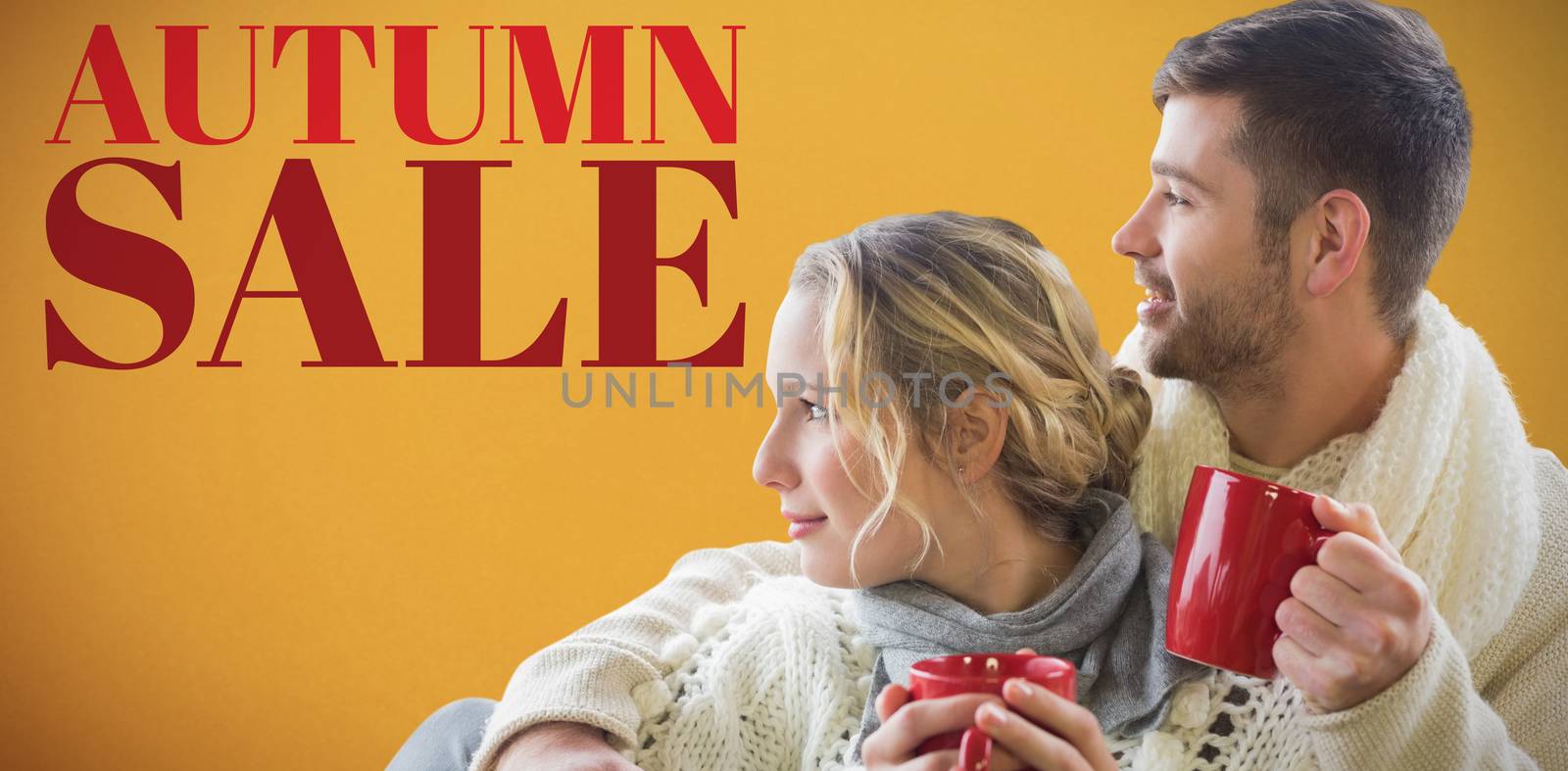  Cheerful couple in winter clothing holding cups against window against orange background