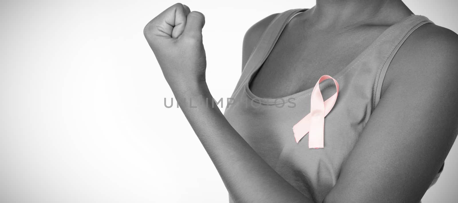 Woman shows pink ribbon for breast cancer awareness on white background