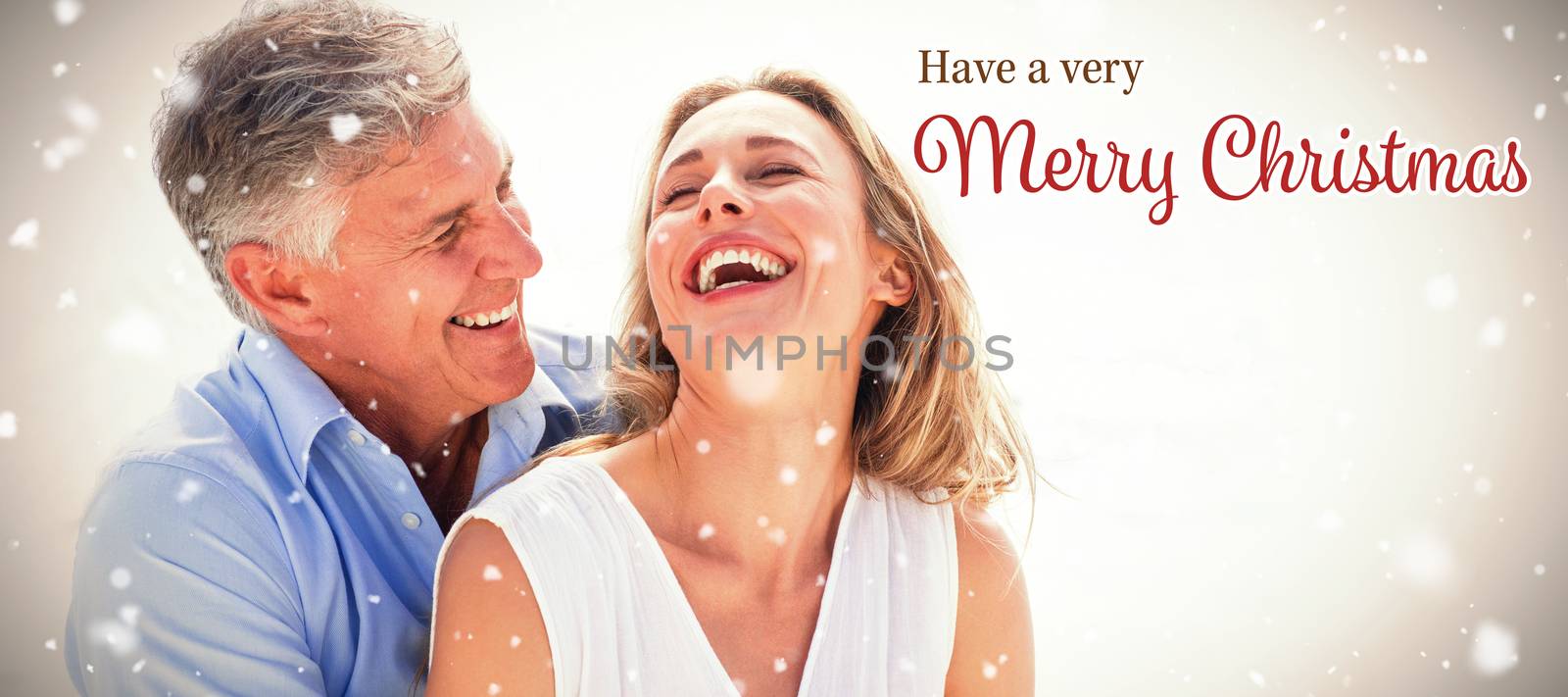Happy couple laughing together against christmas card