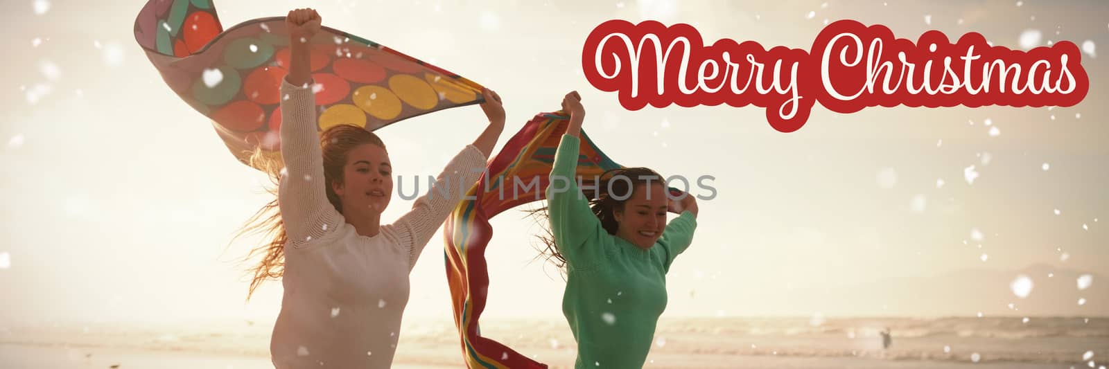 White and red greeting card against female friends running with towel on beach