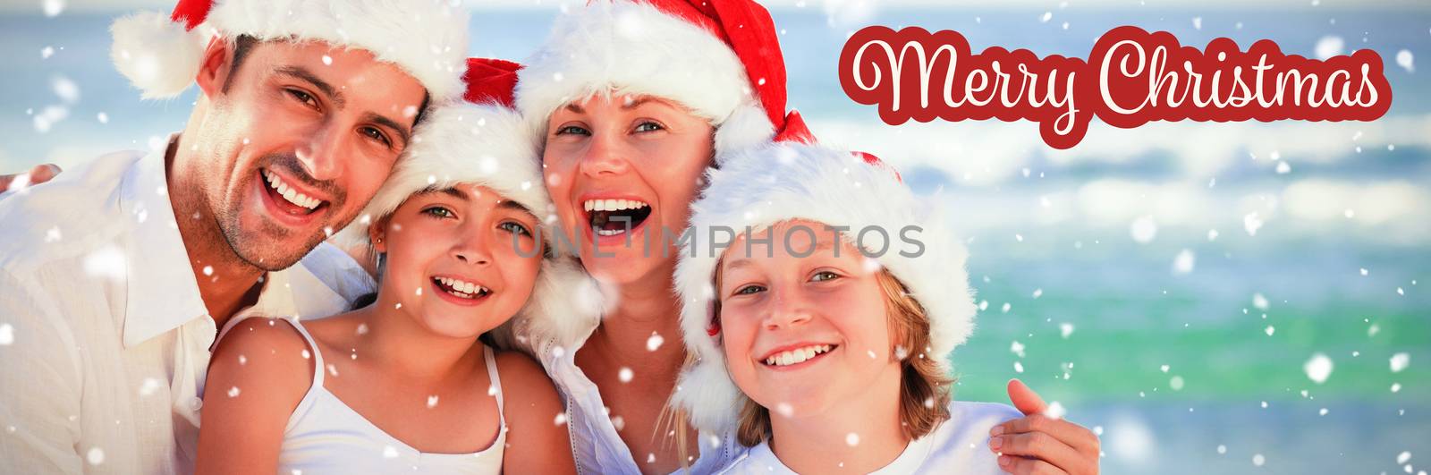 Composite image of family during christmas day at the beach by Wavebreakmedia