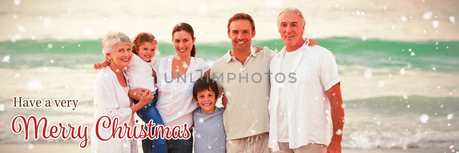 Beautiful family at the beach against christmas card
