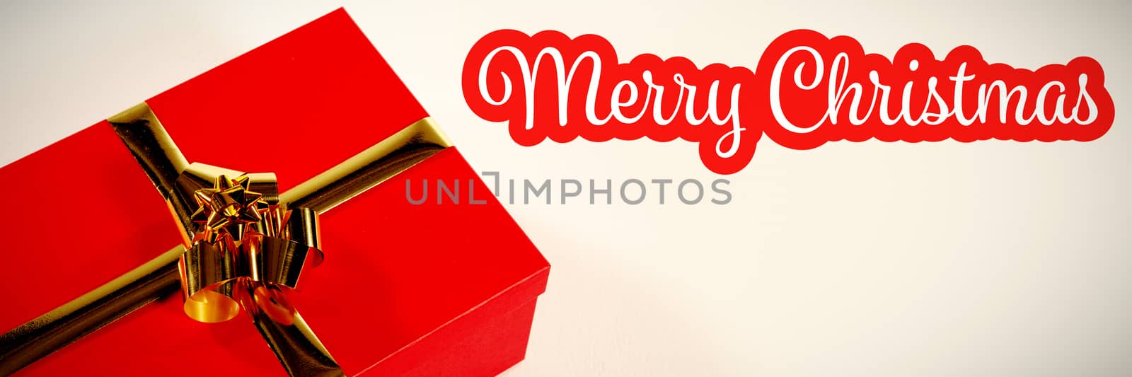 White and red greeting card against red christmas gift on white background