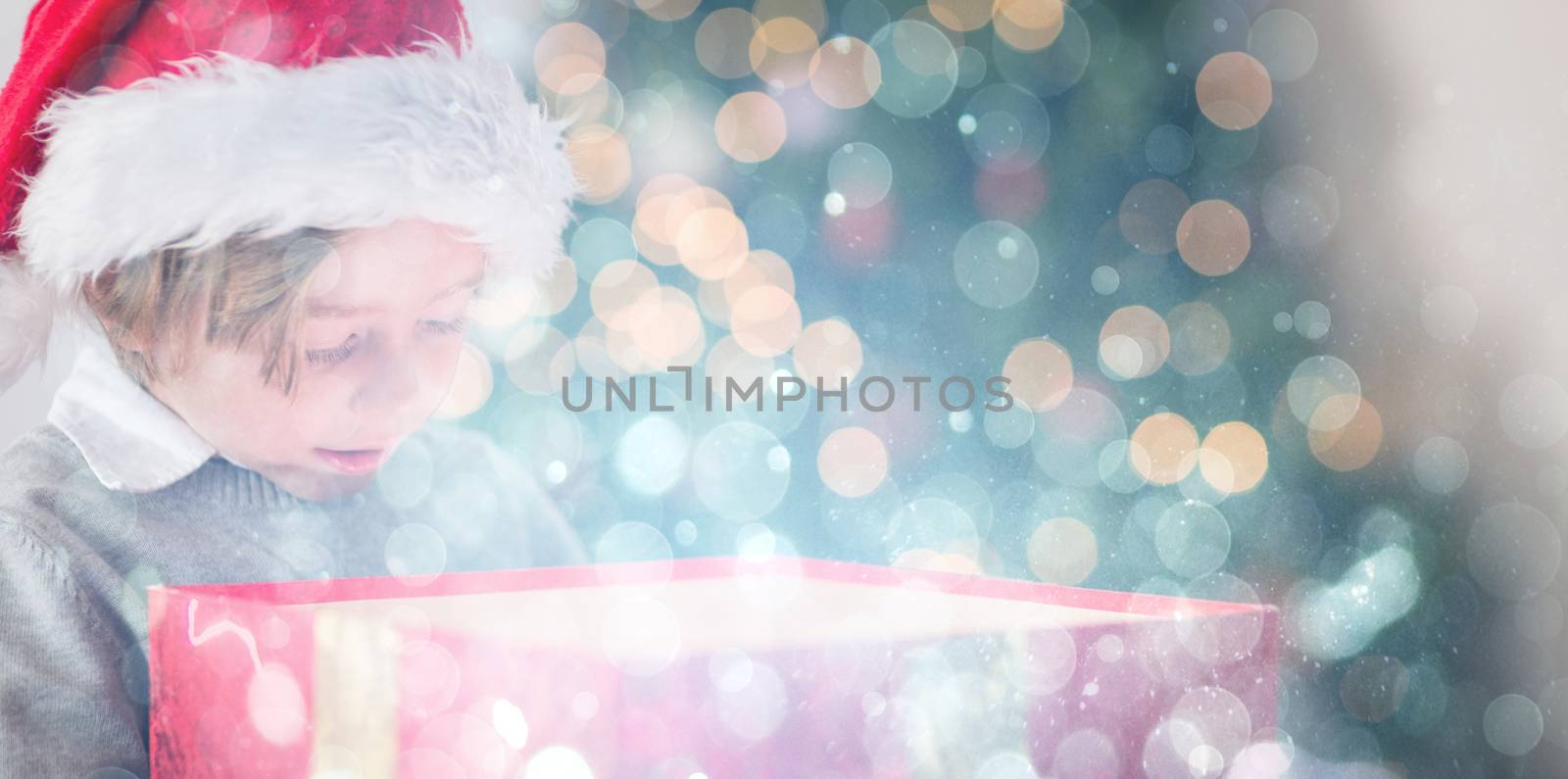 Composite image of child opening his christmas present by Wavebreakmedia