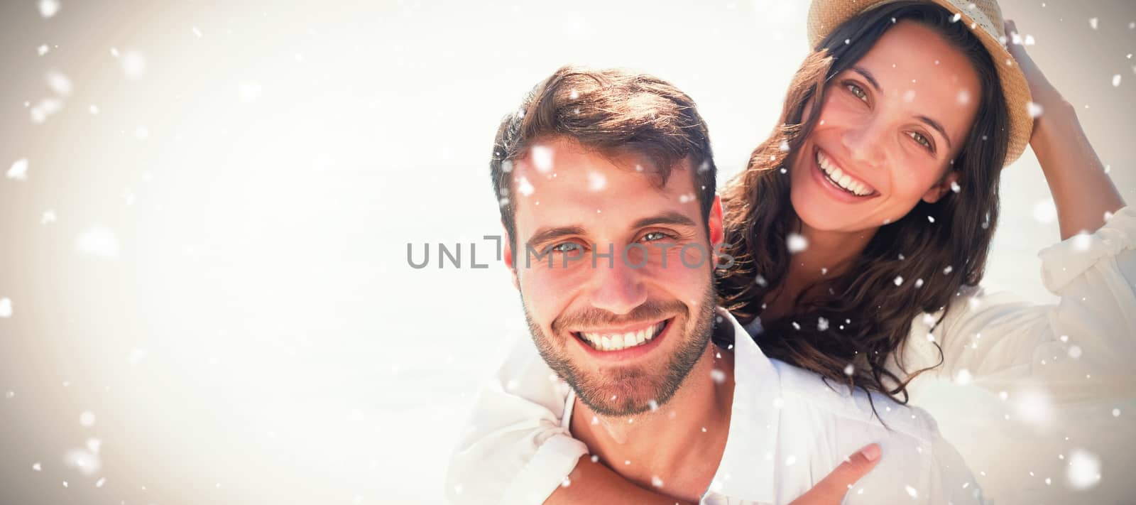 Man doing piggy-back to girlfriend  against snow falling