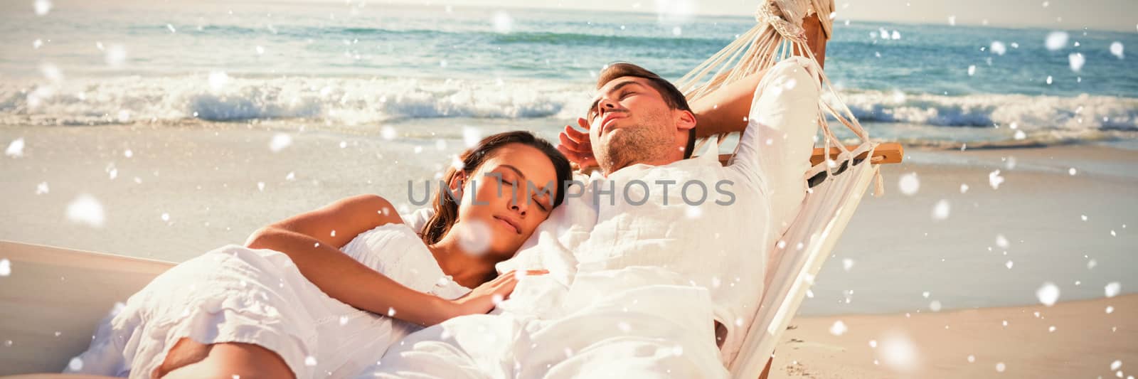 Calm couple napping in a hammock against snow falling