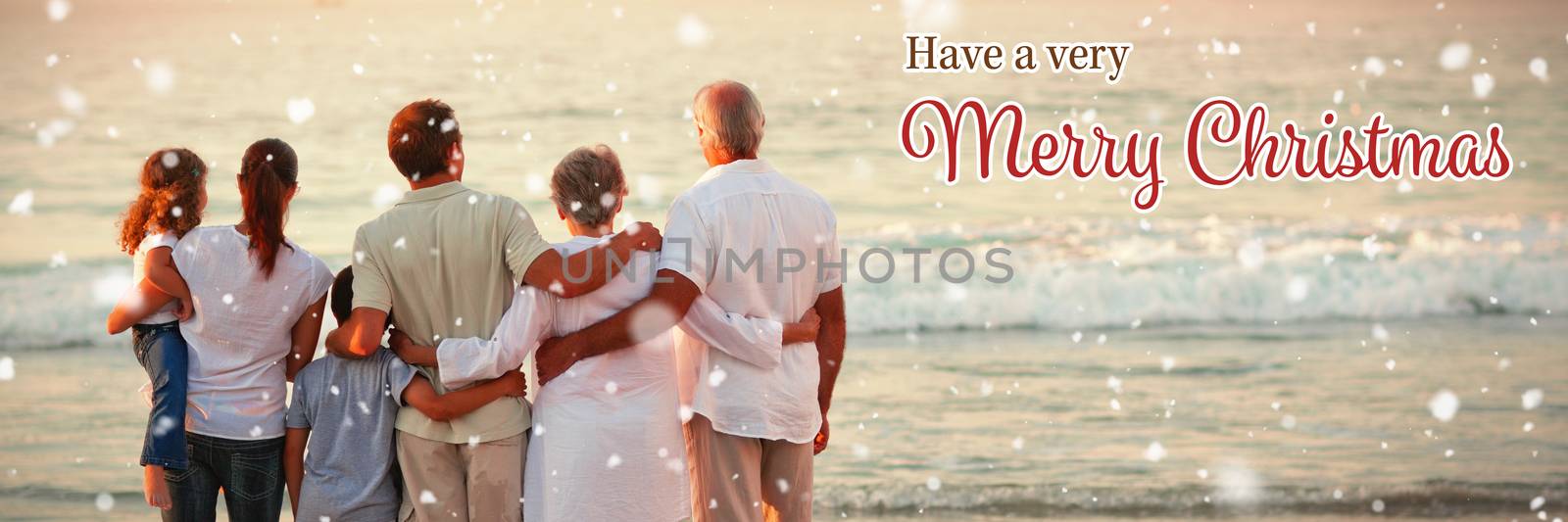 Beautiful family at the beach against christmas card
