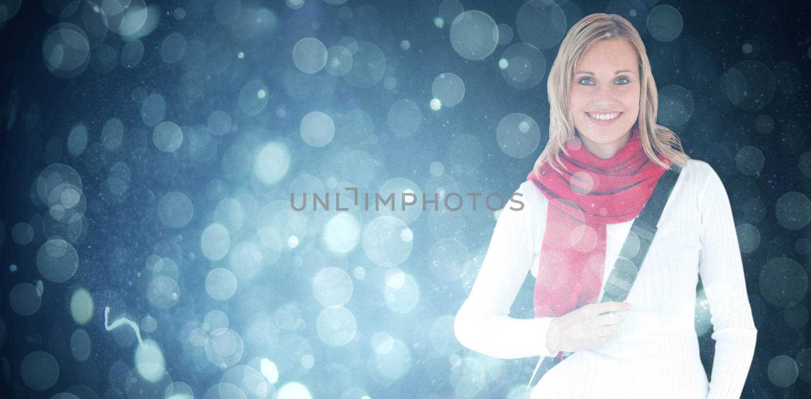 Portrait of a delighted student with scarf smiling at the camera against blue abstract light spot design