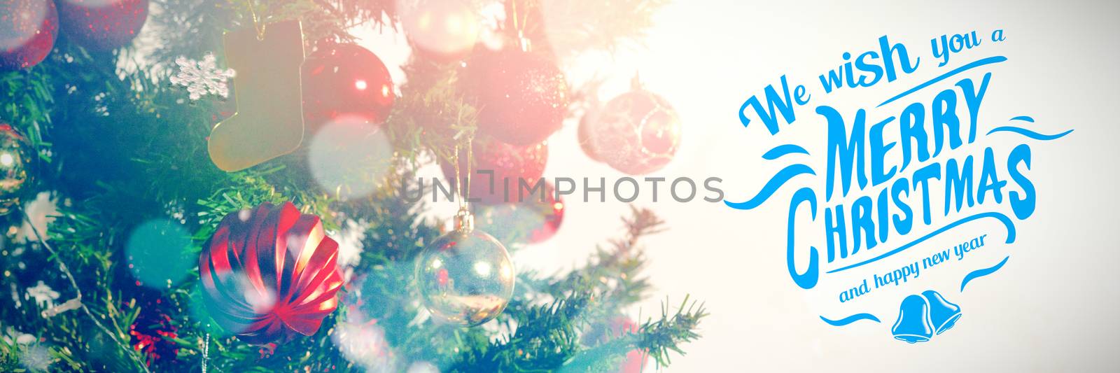 Merry christmas message against defocused lights against snow covered land