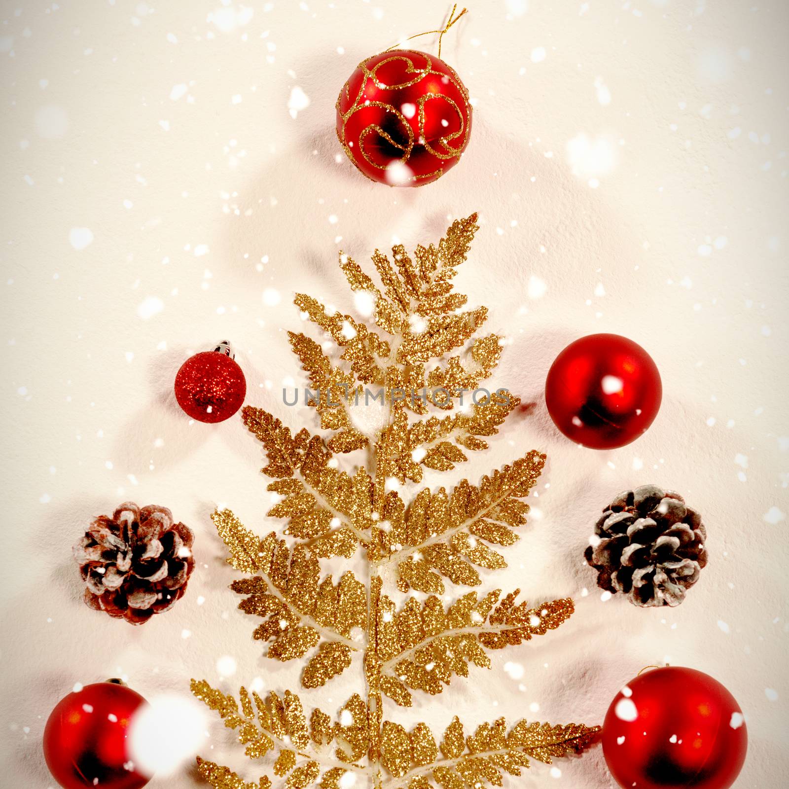 Snow falling against ornaments and decorations with a christmas pine tree shape