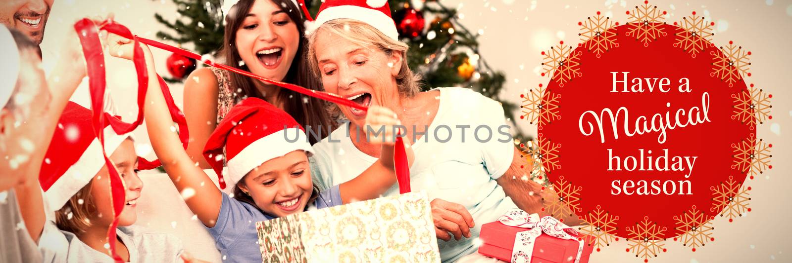 Happy family at christmas opening gifts together against white and red greetings card