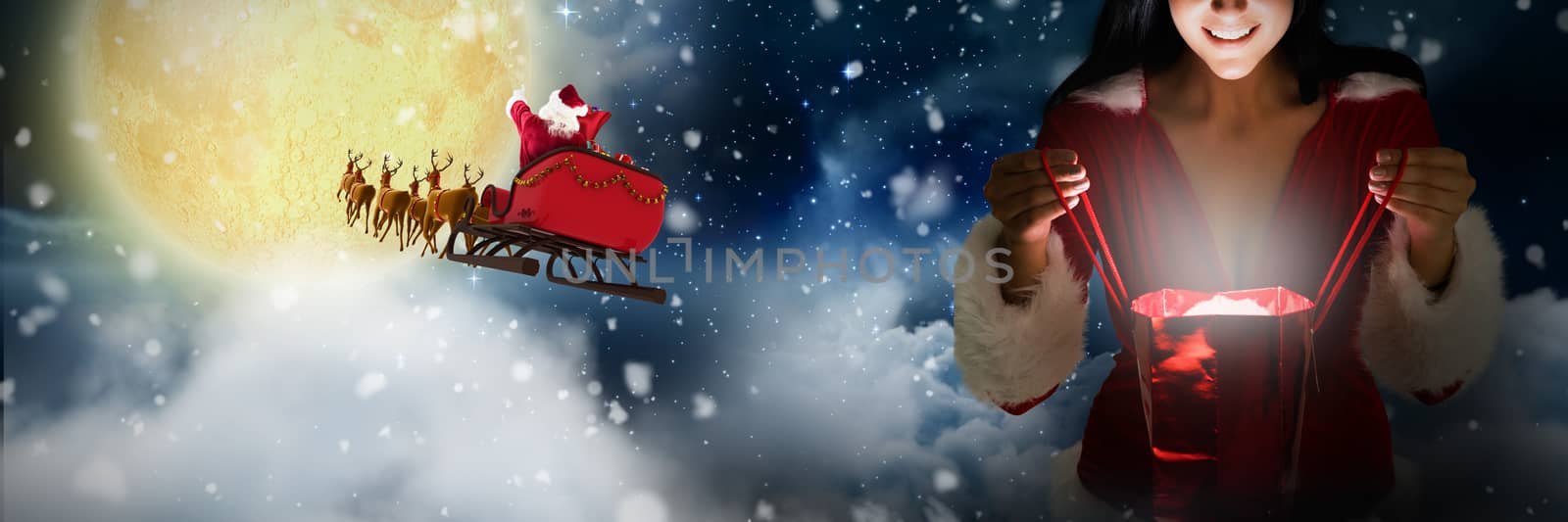 Smiling woman opening christmas present against stars twinkling in night sky