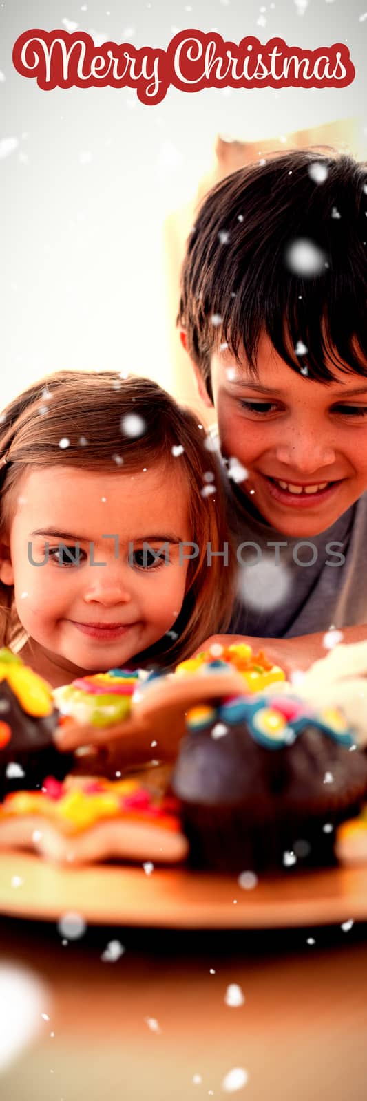 Brother and sister looking at confectionery against white and red greeting card