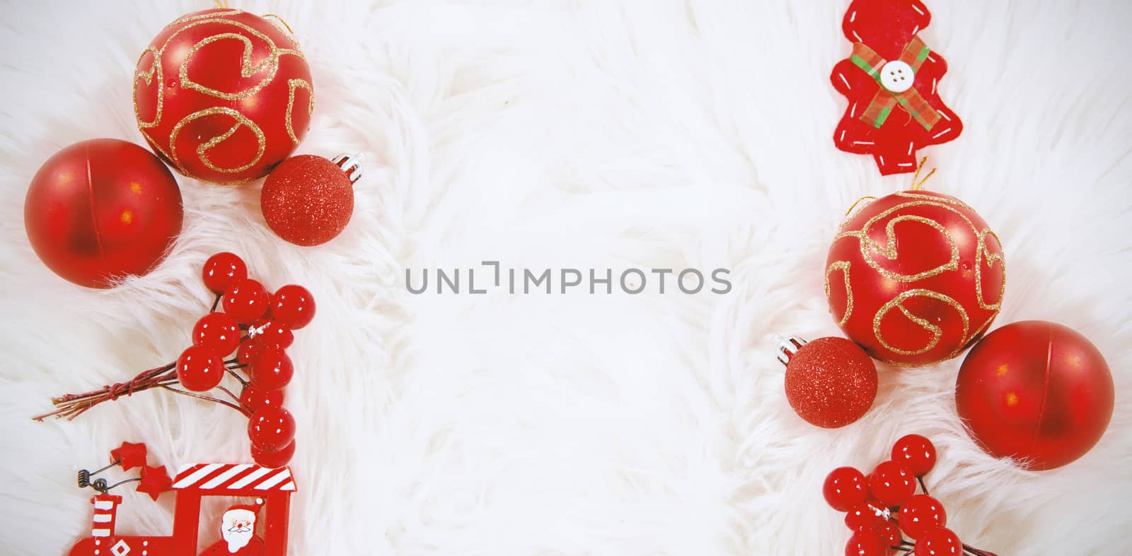 Red Christmas ornament on white fur carpet
