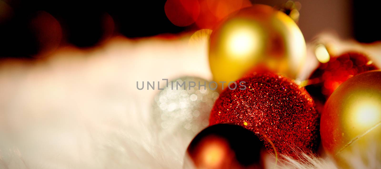 Colored Christmas ornaments on a white carpet