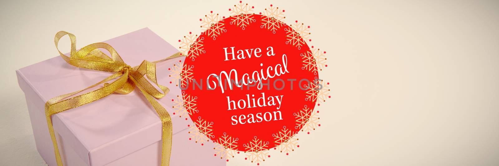 White and red greetings card against christmas gift on white background