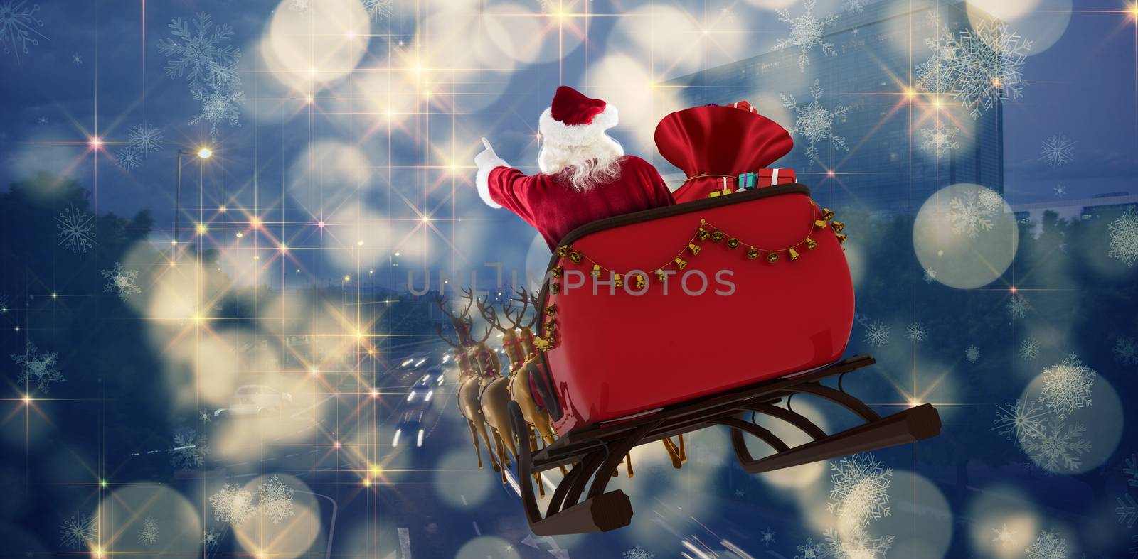 Santa Claus riding on sled with gift box against cars moving on road in city at night