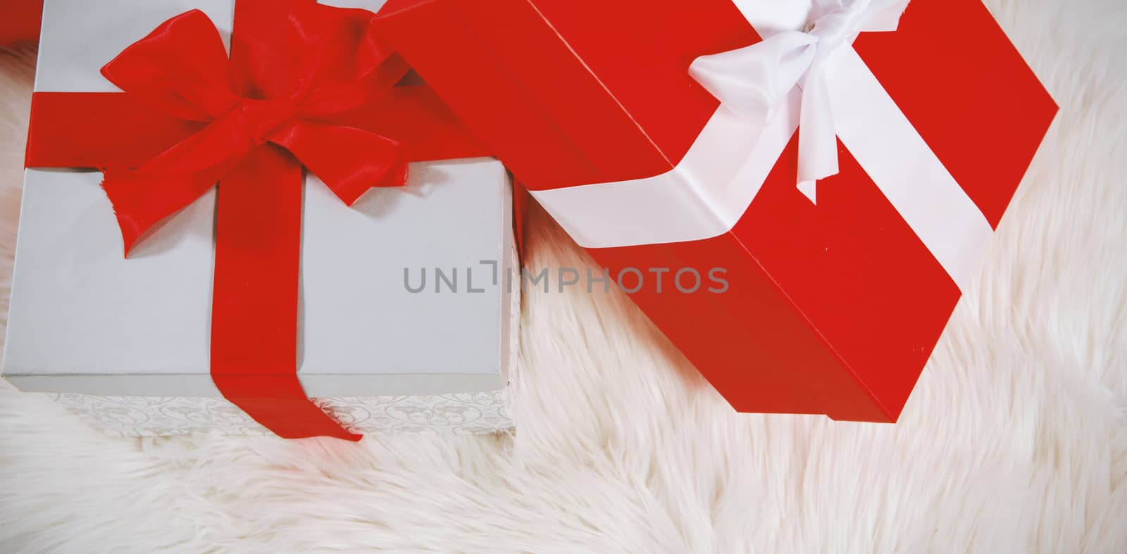 Christmas gifts on a white fur carpet