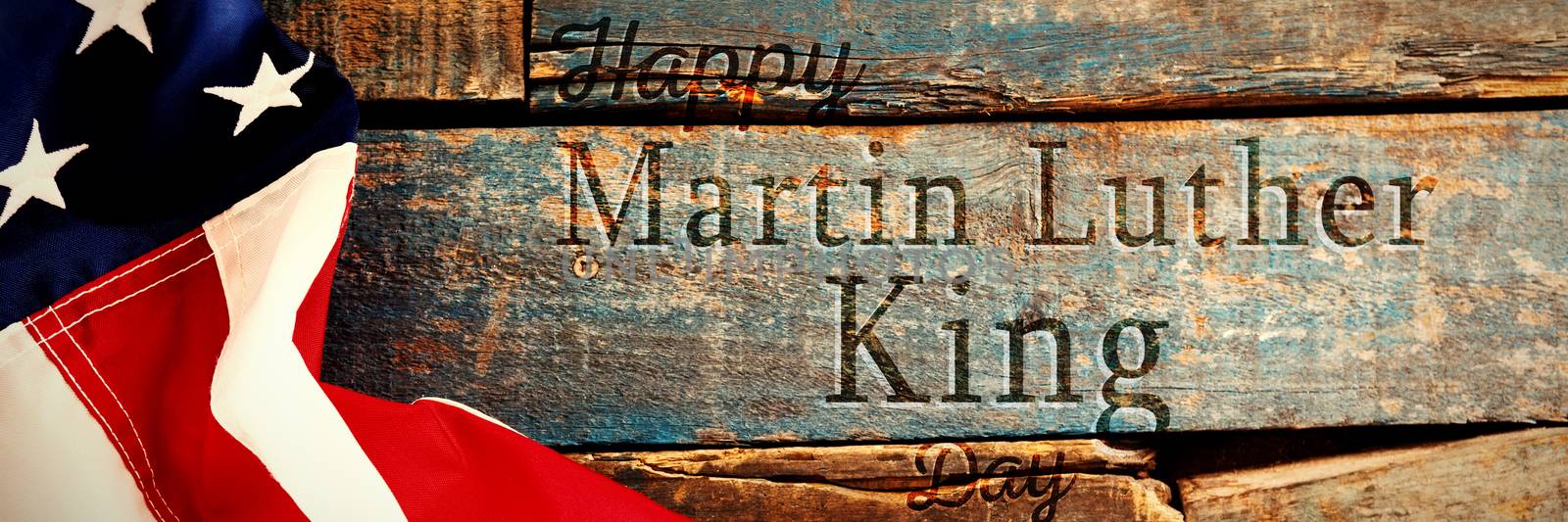 happy Martin Luther King day against american flag on old wooden table
