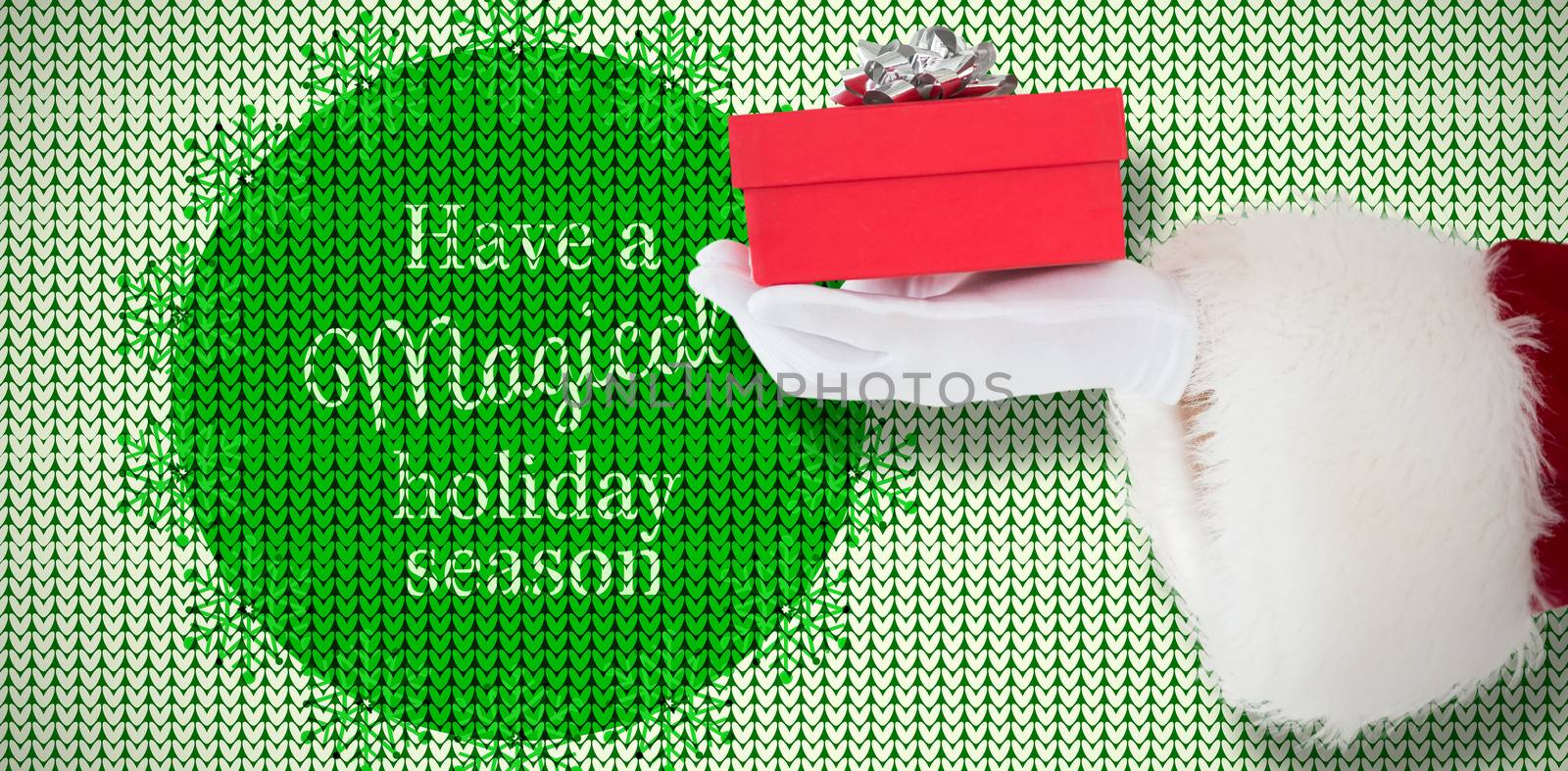 Hand of santa claus holding a gift against white and green pattern 