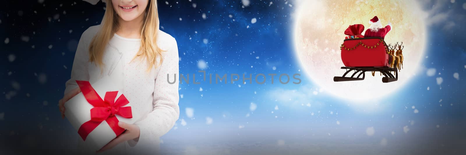 Portrait of happy girl holding Christmas gift against white background against white clouds under blue sky