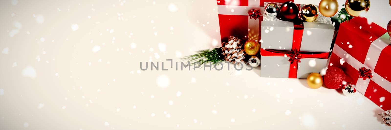 Snow falling against christmas gifts with white copy space