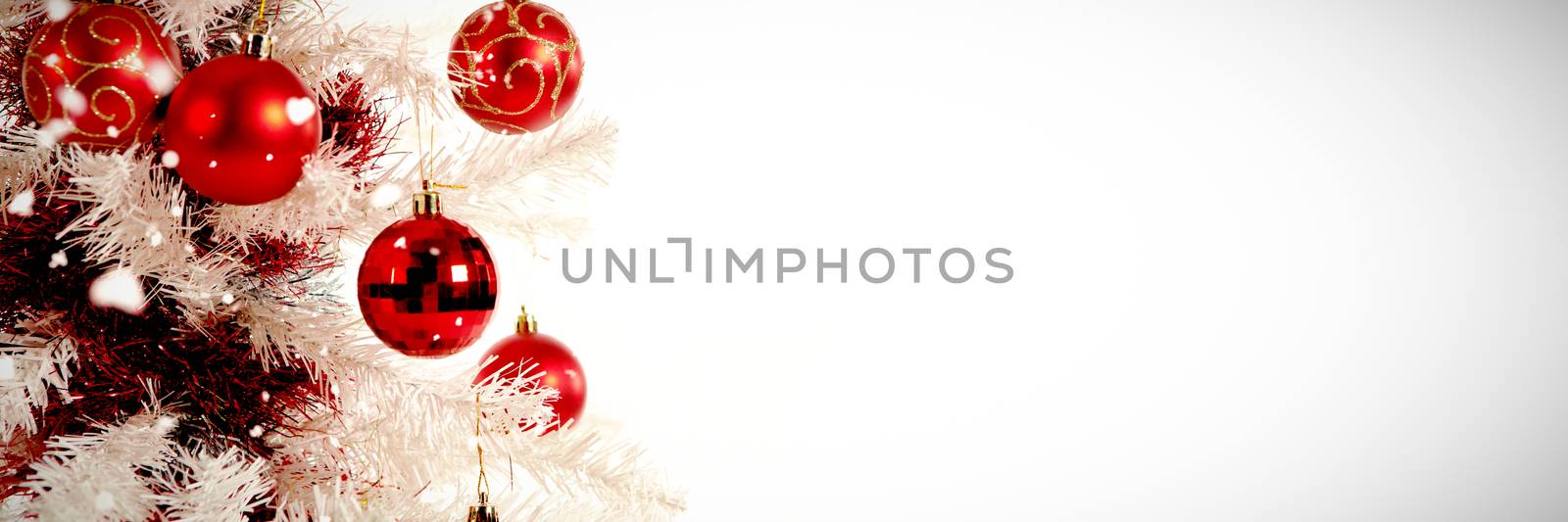 Snow falling against copy space with christmas tree