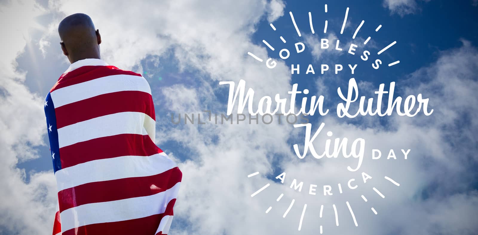 Rear view of man wearing american flag against bright blue sky with clouds