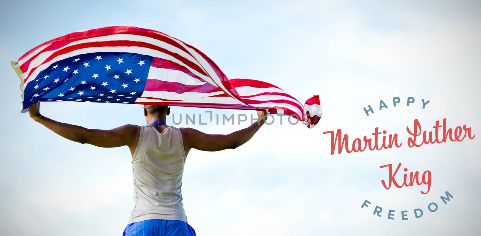 Rear view of sportsman holding american flag  against blue sky with clouds 