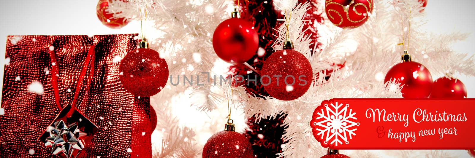 Banner Merry Christmas against close-up of christmas tree and gifts