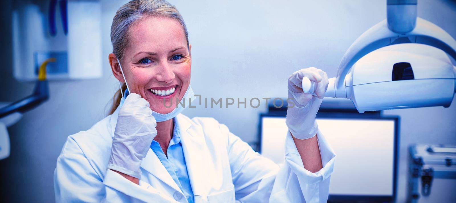 Female dentist holding dental lights in dental clinic
