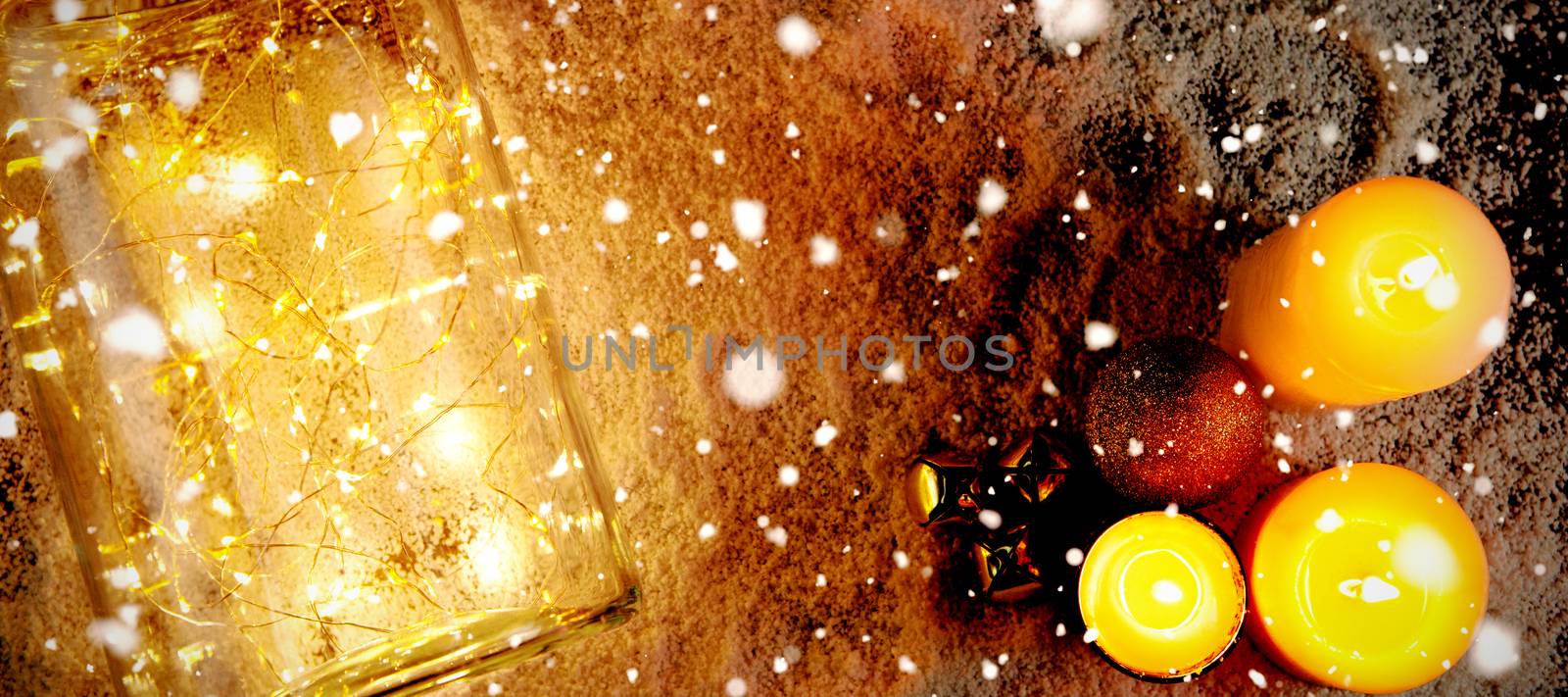 Snow falling against candles and smooth christmas lights