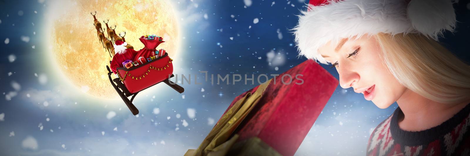 Composite image of festive blonde opening a gift by Wavebreakmedia