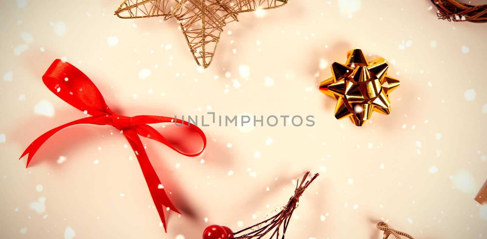 Snow falling against christmas red berries, star and red ribbon