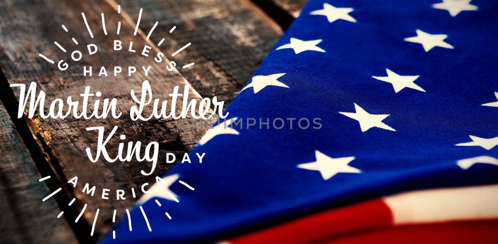 happy Martin Luther King day, god bless america against folded american flag on wooden table